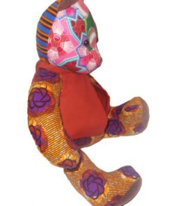 Side view of AfriBloom handmade baby bear plush toy in African wax fabric, soft teddy bear for babies and toddlers, ethical gift made in Belgium
