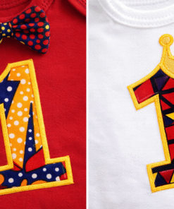 Close-up of African wax fabric “1” applique on baby first birthday onesie with crown detail