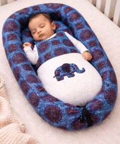 Baby sleeping peacefully in AfriBloom handmade sleeping bag with African wax print