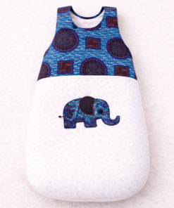 Newborn sleeping bag with African wax print and elephant appliqué, soft and baby-safe, handmade in Belgium.