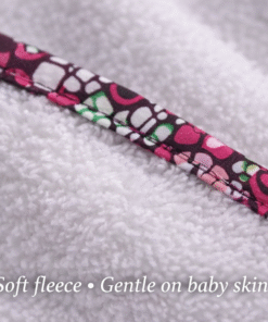 Close-up of soft fleece and African wax bias fabric, gentle and breathable baby textile, handmade nursery set detail