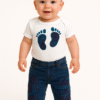 A pair of ripped blue denim jeans for toddlers featuring African print fabric underneath the distressed patches. Elastic waist, unisex design.