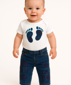 A pair of ripped blue denim jeans for toddlers featuring African print fabric underneath the distressed patches. Elastic waist, unisex design.