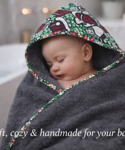 Baby wrapped in a handmade hooded towel after bath, African wax print baby nursery set, soft and cozy newborn essentials by AfriBloom