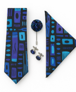Elegant men’s African print necktie set in blue and indigo geometric Ankara fabric, including tie, pocket square, boutonnière and cufflinks, displayed with a beige suit.