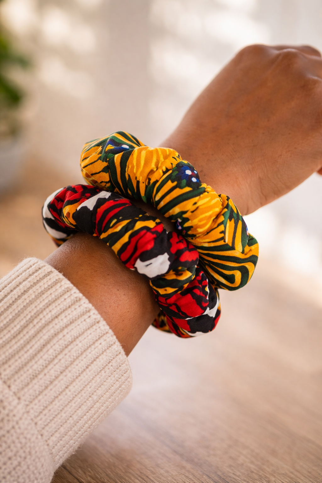 AfriBloom wax scrunchies worn on wrist showing real size, handmade African print hair accessories