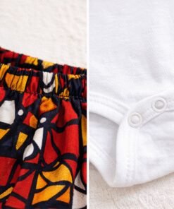 Close-up of African wax fabric shorts and cotton baby onesie with snap buttons