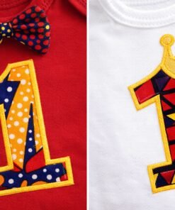 Close-up of African wax fabric “1” applique on baby first birthday onesie with crown detail