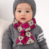 Baby wearing a soft African print scarf, styled comfortably around the neck, handmade baby fashion accessory.
