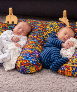 Two newborn babies sleeping comfortably on a handmade African patchwork twin baby support pillow, double infant lounging pillow by AfriBloom