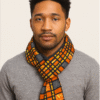 Unisex African print scarf worn by model, handmade statement scarf with colorful wax fabric, warm and stylish accessory