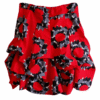 Short ruffled African wax skirt in red, black and grey floral circular print, handcrafted – product photo on white background.