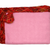 Baby blanket with soft pink fleece center and red African wax border, folded neatly with a matching decorative corner.