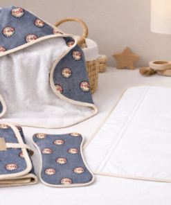 AfriBloom newborn care essentials arranged in a neutral nursery setting with woven basket and soft light