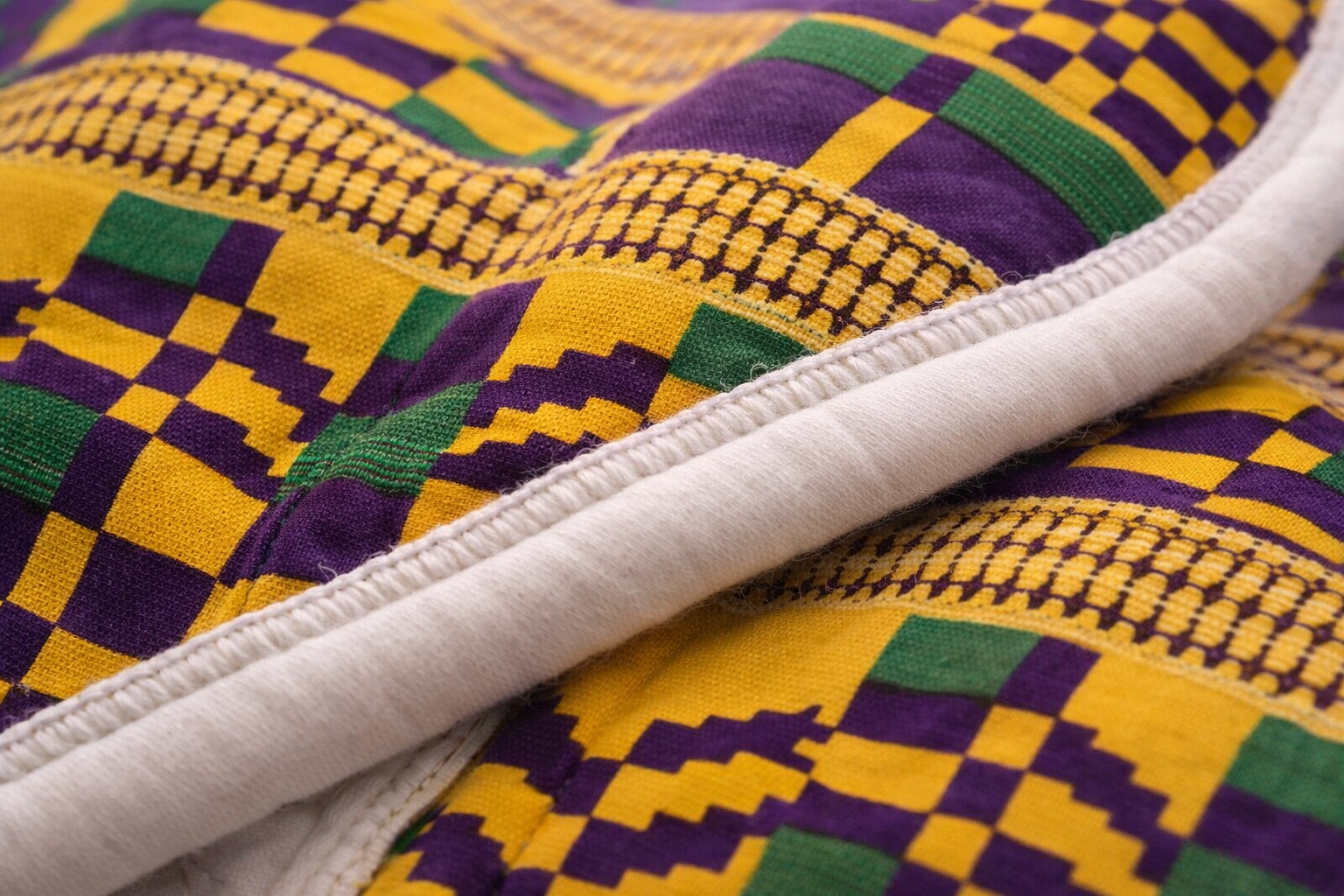 African print baby swaddle close-up showing soft cotton fabric, quality stitching and breathable handmade finish
