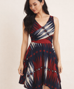 Asian woman wearing African handkerchief dress, flattering sleeveless design with flowy asymmetrical hem.