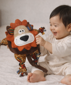 Asian baby playing with AfriBloom handmade lion plush toy made with African wax fabric