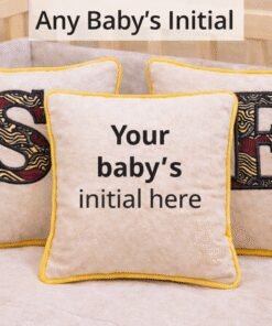 Personalized baby cushion with African print appliqué showing custom initials, handmade nursery pillow gift