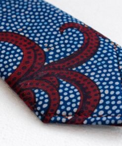 Close-up of AfriBloom handmade African wax print necktie showing stitching, fabric texture, and pointed tip detail, made in Belgium