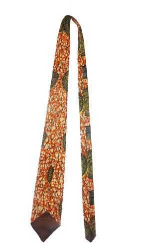 Handmade African wax print necktie by AfriBloom, laid flat showing pointed tip and vibrant Ankara pattern, ethical men’s accessory made in Belgium
