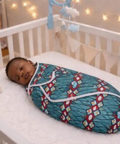 African print baby swaddle with sleeping newborn in crib, handmade breathable cotton wrap for infants