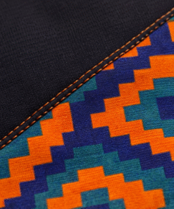 Close-up of African print diagonal panel with premium stitching on women’s black sweatshirt
