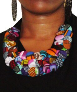 Handmade African statement necklace made from colorful wax print fabric buttons worn on black dress