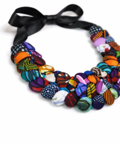 Handmade African statement necklace side angle showing wax print fabric buttons and ribbon tie detail
